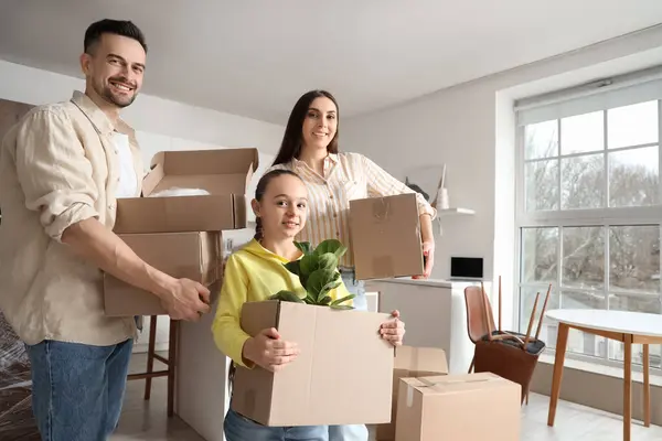 Happy family with cardboard boxes in kitchen on moving day