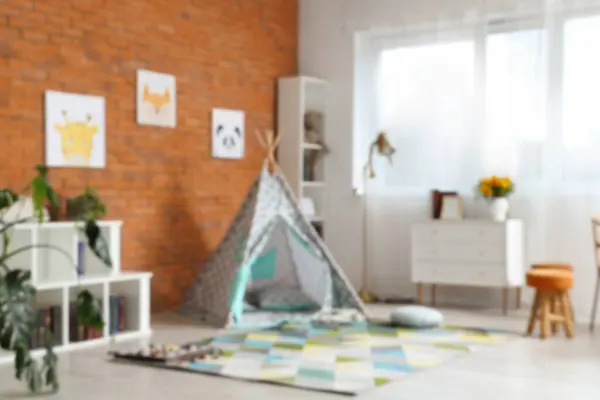Blurred view of children\'s room with play tent
