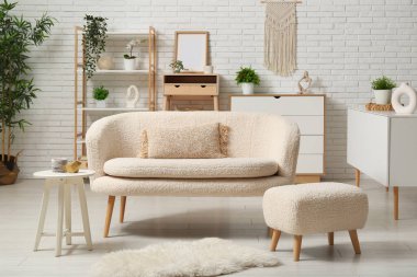 Beyaz rahat kanepe, oturma odasında da halı var.