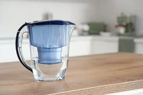 Blue water filter jug on table in kitchen
