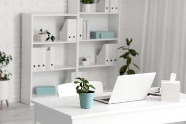 Doctor's workplace with laptop in modern clinic