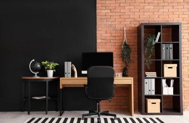 Çalışma yeri, raf ünitesi ve masası olan modern ofis.