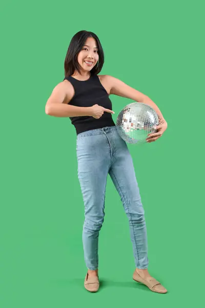 Young Beautiful Asian Woman Pointing Disco Ball Green Background — Stock Photo, Image