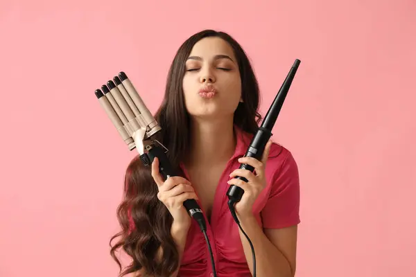 Beautiful Young Woman Different Curling Irons Pink Background — Stockfoto