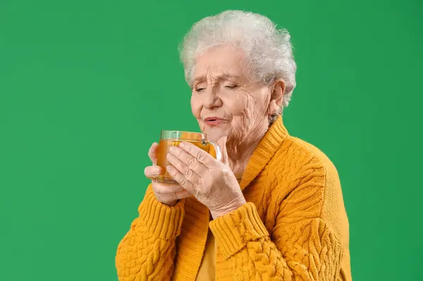Senior Woman Glass Cup Hot Tea Green Background Stock Photo