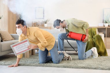 Young men with evacuation plan and fire extinguisher in burning building clipart