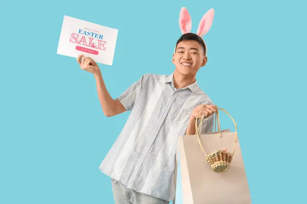 Junger Asiatischer Mann Hasenohren Mit Einkaufstaschen Und Korb Auf Blauem — Stockfoto