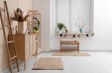 Stylish interior of light living room with Easter decor