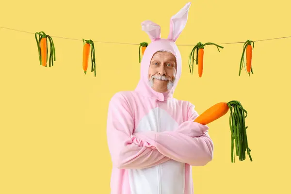 Senior Man Easter Bunny Costume Plush Carrots Yellow Background — Stock Photo, Image