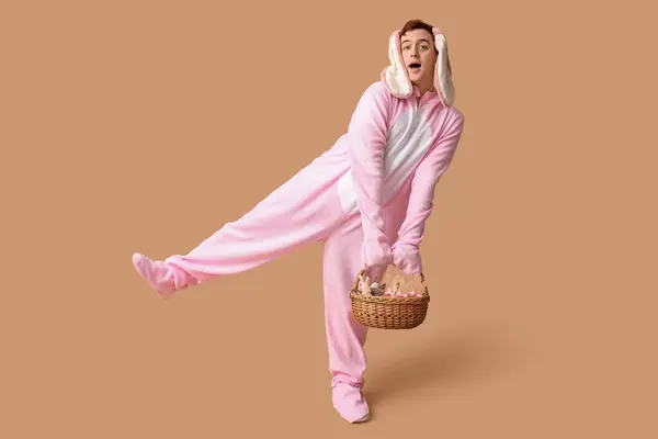 Surprised Young Man Easter Bunny Costume Basket Beige Background — Stock Photo, Image