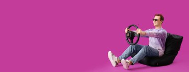 Mor arka planda direksiyonlu, metin için yeri olan oturan genç adam.