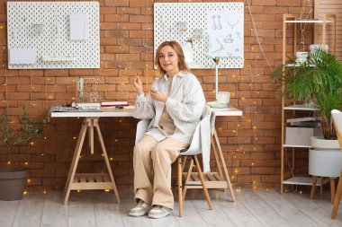 Atölyede yüzüğü olan bir kadın kuyumcu.