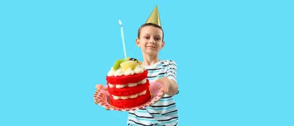 stock image Cute little boy with Birthday cake on blue background