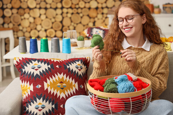 Young woman with knitting yarn at home