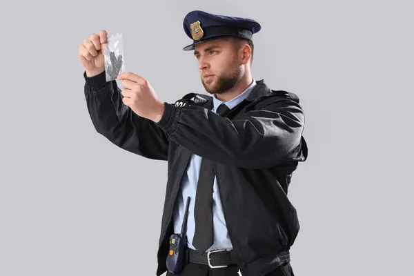 Male Police Officer Evidence Grey Background Royalty Free Stock Images