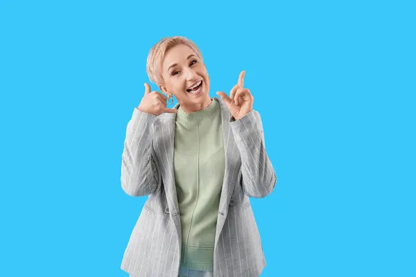 Cool Mature Woman Showing Call Gesture Light Blue Background — Stock Photo, Image