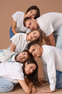 Kahverengi arka planda bir grup şık genç.