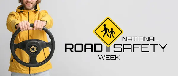 Man with steering wheel on light background. Banner for National Road Safety Week