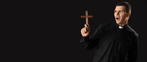 Emotional Young Priest Holding Cross Dark Background Space Text — Stock Photo, Image