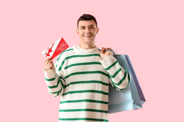 Young Man Gift Voucher Shopping Bags Pink Background — Stock Photo, Image
