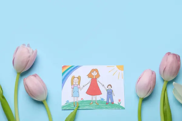 Kid drawing with tulips on blue background. Mother's Day celebration