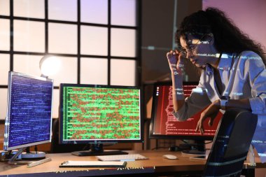 Geceleri masa başında çalışan Afro-Amerikalı bir programcı.