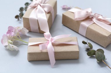 Mavi arka planda çiçeklerle süslü hediye kutuları