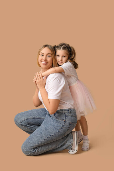 Mother playing with her child on beige background. Mother's Day