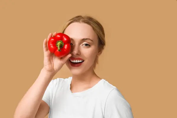 Stock image Young woman with bell pepper on beige background, closeup