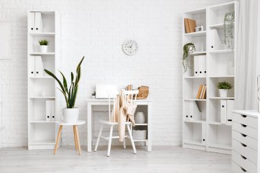 Çatı katında sandalye, ev bitkisi ve dizüstü bilgisayarı olan işyeri