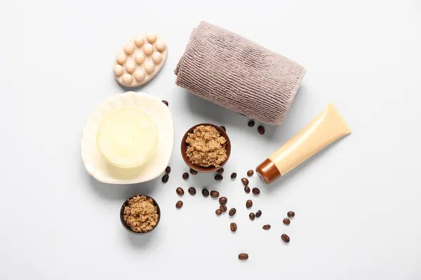 Scrubs with cream, towel and soap on white background. Body massage concept