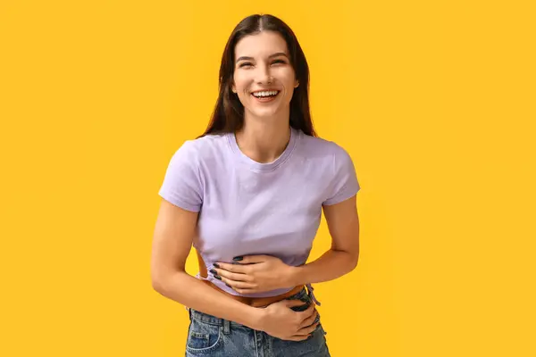 黄色い背景で笑っている美しい幸せな若い女性 — ストック写真