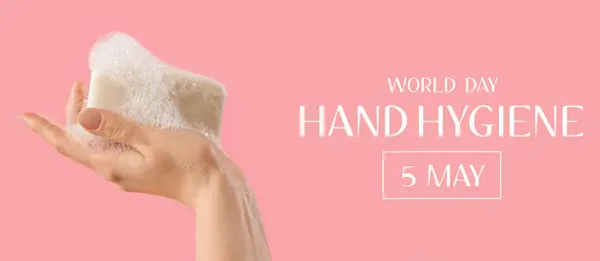 Female hand with soap bar on pink background. Banner for World Hand Hygiene Day