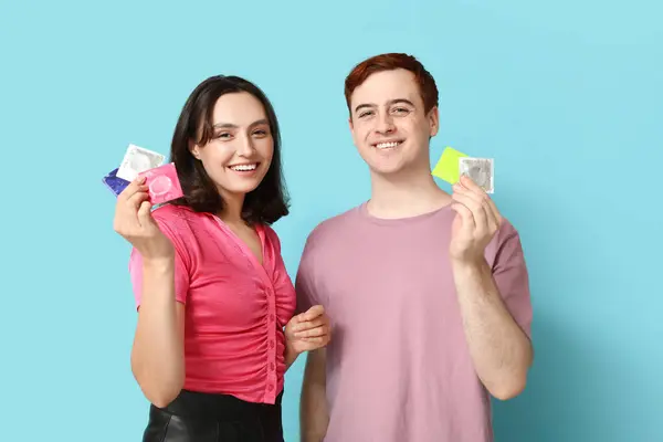 Young Couple Condoms Blue Background Safe Sex Concept — Stock Photo, Image