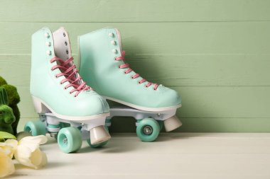 Beyaz ahşap masada güzel laleleri ve oyuncak tavşanları olan klasik patenler. Paskalya kutlaması