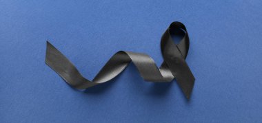Black funeral ribbon on blue background, top view clipart