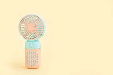 Bej arka planda mini elektrikli vantilatör