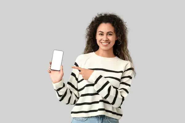 Young African American Woman Pointing Mobile Phone Blank Screen Grey — Stock Photo, Image