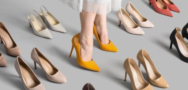 Genç kadın bacakları ve gri arka planda zarif yüksek topuklar.