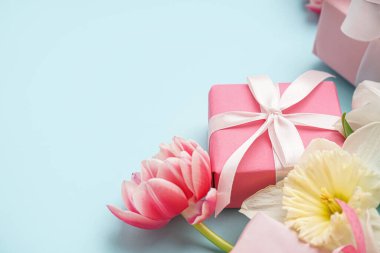 Mavi arka planda güzel lale ve nergis çiçekli hediye kutuları.