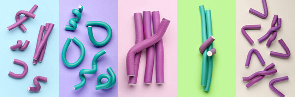 Set of many hair curlers on color background, top view