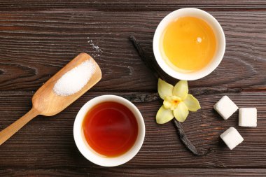 Vanilya özlü kompozisyon, bal ve şeker koyu ahşap arka planda