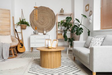 Oturma odasının içinde rüzgar çanı, kanepe ve masa.