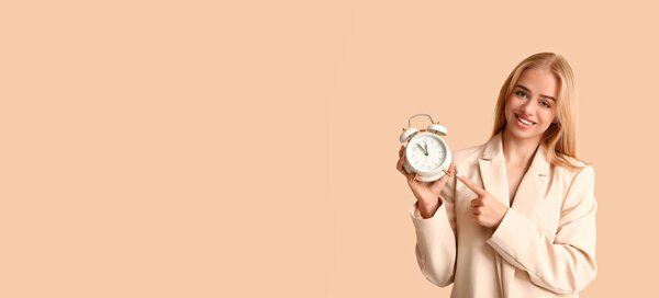 Happy businesswoman with alarm clock on beige background with space for text. Time management concept