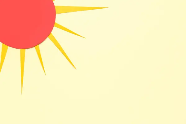 Bright paper sun on yellow background