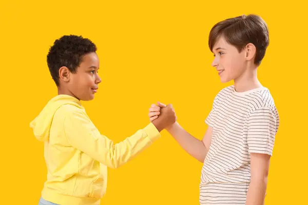 Little Boys Holding Hands Yellow Background Children Day Celebration Stock Photo
