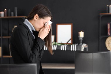 Mourning young woman crying at funeral clipart