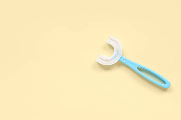 Children's toothbrush on yellow background