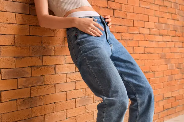 Young Woman Stylish Jeans Pants Orange Brick Wall — Stock Photo, Image