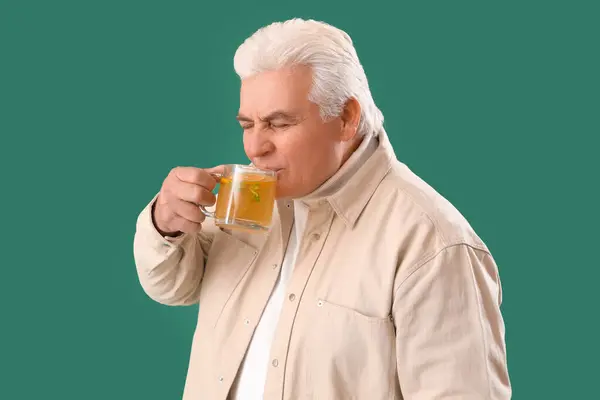 Mature Man Drinking Lemon Tea Green Background — Stock Photo, Image